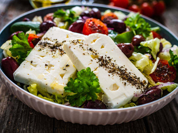 istock Feta cheese salad on wooden table 1460231836