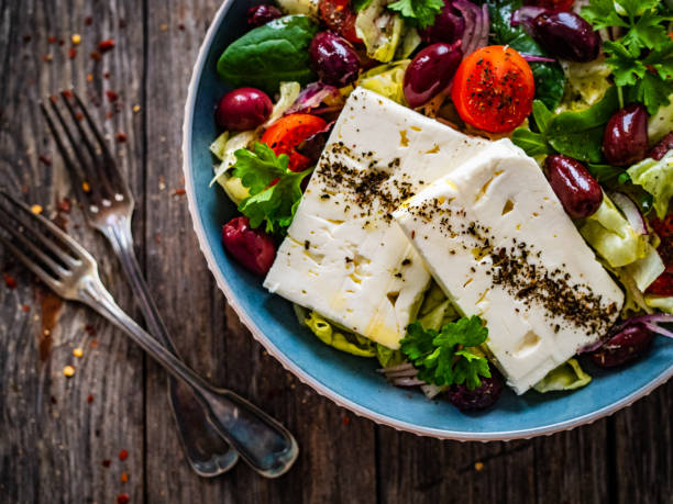 istock Feta cheese salad on wooden table 1460231897