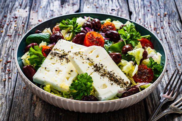 istock Feta cheese salad on wooden table 1460231973
