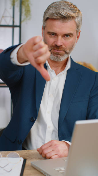 istock Upset businessman showing thumbs down, dislike bad work, disapproval dissatisfied feedback at office 1460234923