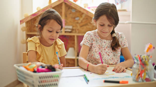 istock Sisters at home drawing and painting together 1460236457