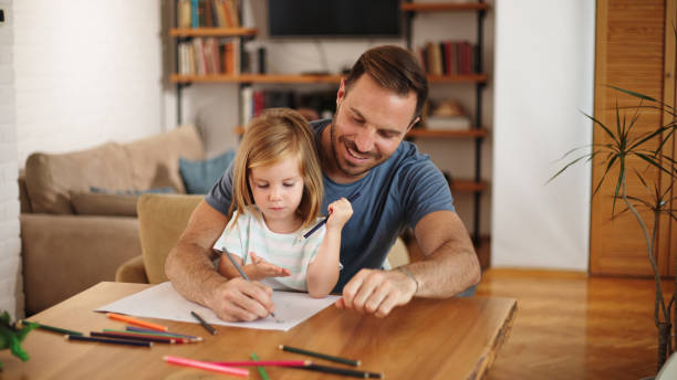 istock Father and daughter having good time drawing at home together 1460236822