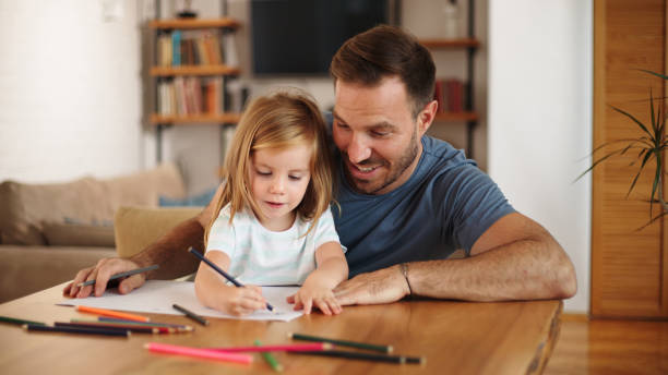istock Father and daughter having good time drawing at home together 1460236851