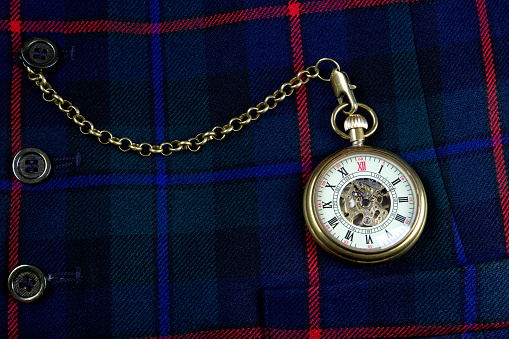 Scottish tartan waistcoat with old pocket watch and chain closeup