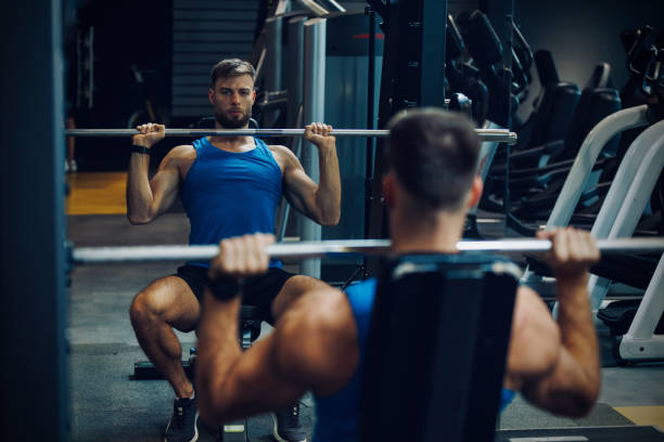 istock Bodybuilder doing heavy barbell exercise at the gym 1460237104