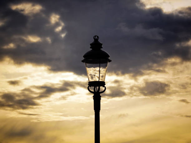Low angle view of street light against cloudy sky