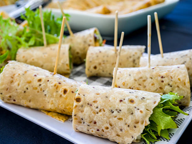 Flat bread wrapped with green lettuce and other ingredients stock photo
