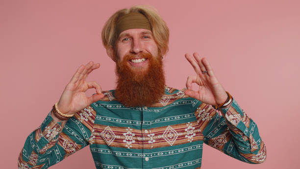 istock Hippie man looking approvingly showing ok approve feedback gesture like sign positive something good 1460243363