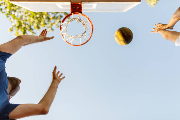 istock Basket ball flying over the hoop while father and son are playing 1460243905