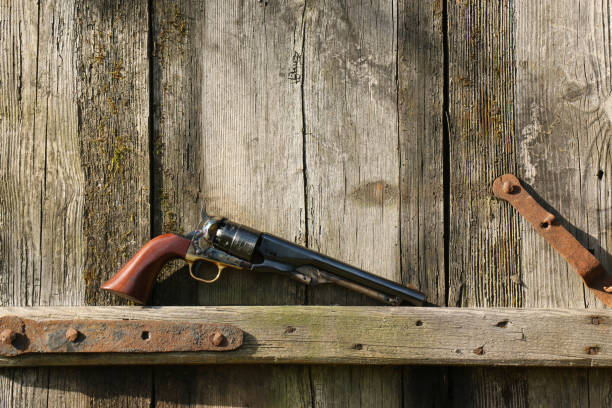 istock Black powder percussion revolver 1860 Colt Army on an old board. 1460247285