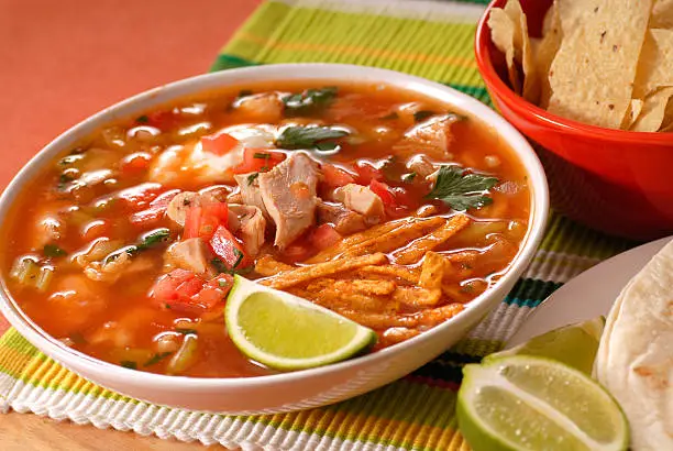 Photo of Bowl of chicken and tortilla soup with lime