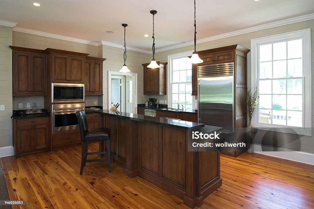 luxury kitchen in dark wood luxury kitchen in dark wood and granite with stainless appliances Appliance Stock Photo