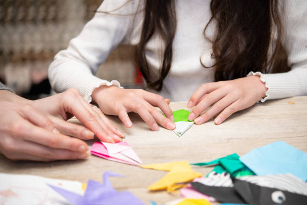 istock mother and daughter playing with origami 1460252207