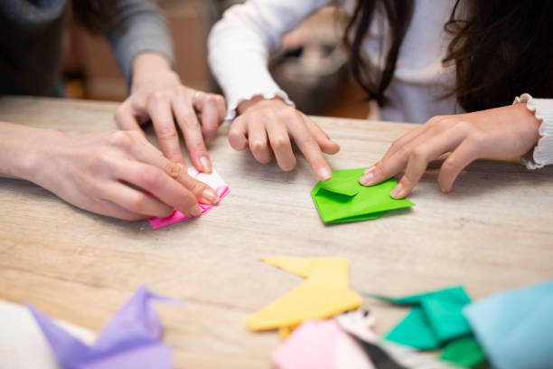 mother and daughter playing with origami