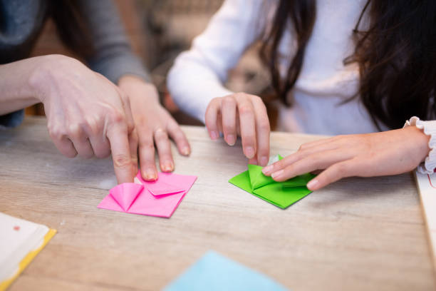 istock mother and daughter playing with origami 1460252212
