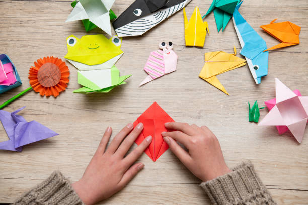 istock Girl's hand playing with origami 1460252225