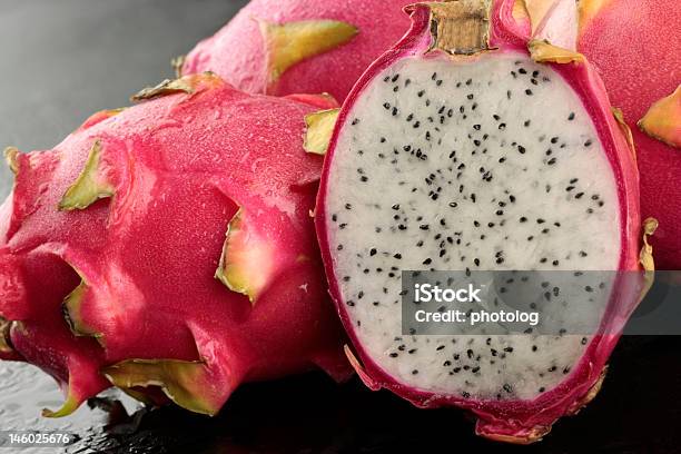 Dragon Fruit Whole And Sliced In Half On Black Background Stock Photo - Download Image Now