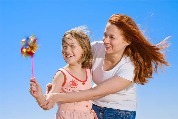 istock Mother and daughter with pinwheel 146025849