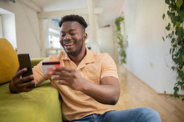 istock Man using his credit card to shop online 1460260050