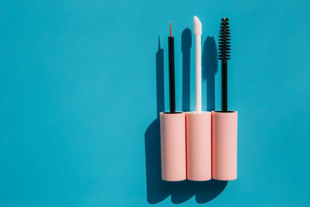 istock pink brushes for cosmetics, mascara, liquid lipstick, eyeliner, lip gloss on a blue background, copy space 1460260409