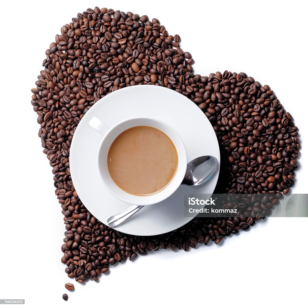 Top view of coffee cup with heart shaped beans Top view of coffee cup with heart shaped beans in the background Addiction Stock Photo