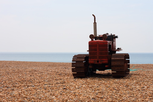 Lonely old tractor on the beach.