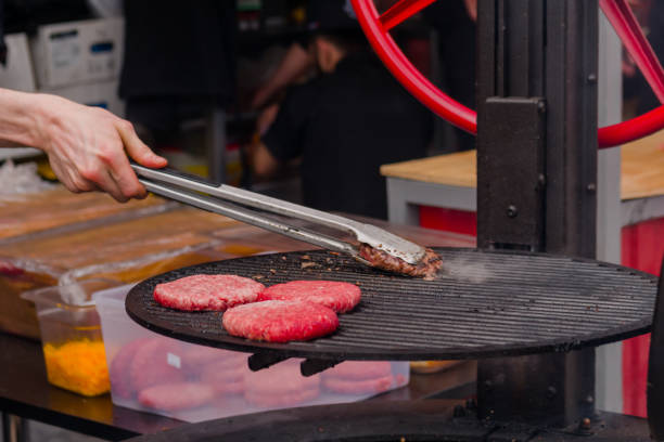 istock Chef grilling meat cutlets for burgers - close up 1460262529