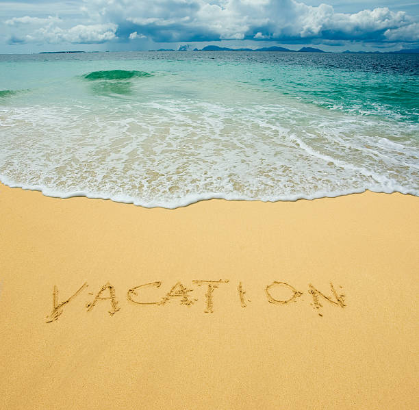 istock vacation written in a sandy tropical beach 146026515