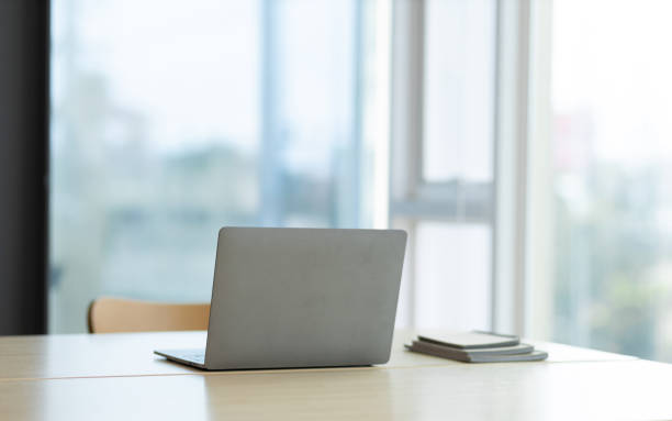 istock Laptop on a desk in an open financial office. 1460265250