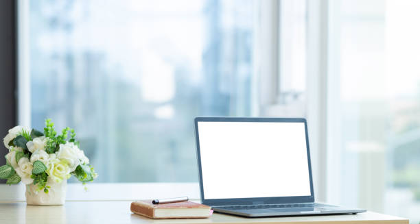 istock Laptop blank white screen on desk in financial office. 1460265257