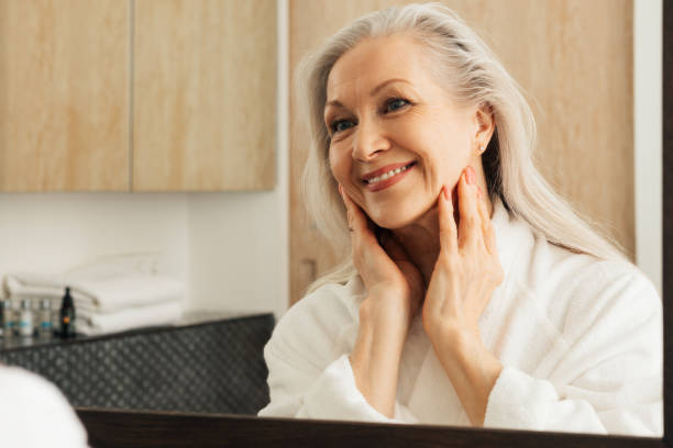istock Cheerful aged female looking at her reflection in the morning 1460266693