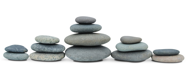 Balancing stones are arranged in a row on a white background.