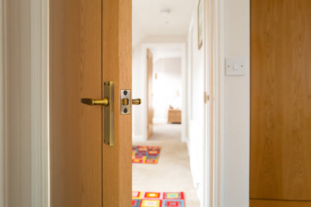 Shallow focus of an opened bedroom door looking towards a large, first floor landing. stock photo
