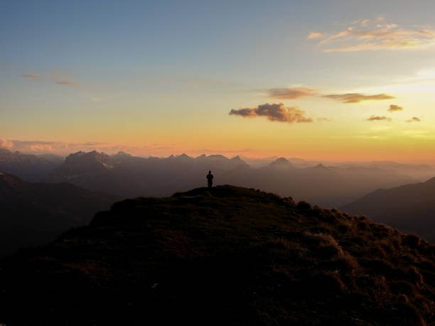 istock Mountain Sunset with one Person 1460270382