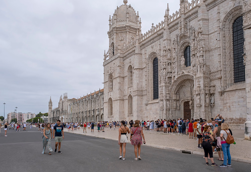 a long queue of tourists waiting to enter the Jeronimos Monastery in Belem, Lisbon Portugal, horizontal