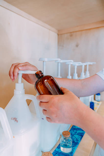 istock Young Woman's Hands Pumping Shampoo from a Bottle, Making Sustainable Choices at a Plastic-Free Retail Store 1460272315