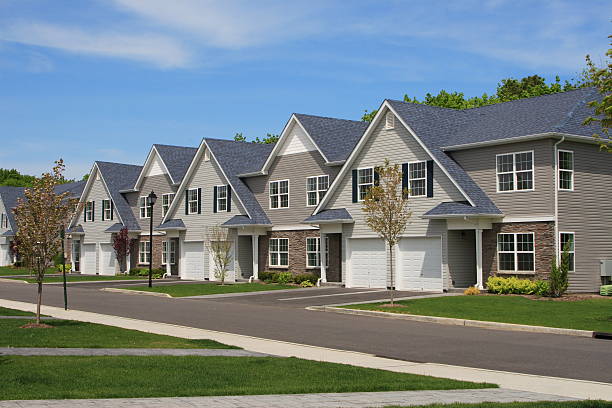 istock Row of townhouses with triangular roofs on residential road 146027360