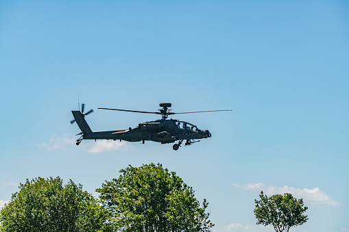 Apache in combat. Helicopter battle training, low flight in natural airfield on Suur-Pakri island, Estonia, Europe.