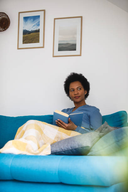 istock Contemplating about the plot in the book that she is reading 1460275868