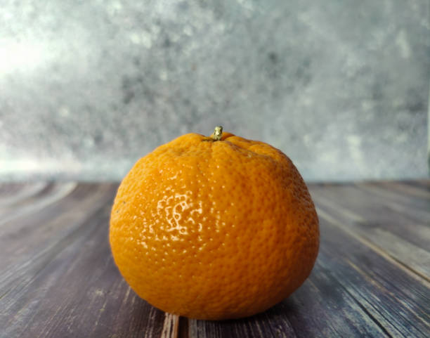 istock Tangerine on a wooden table on a gray background 1460276052