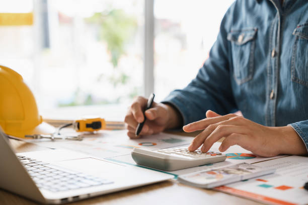 istock Businessmen are planning budgets for construction projects, analyzing company financial statements, managing global construction project costs. 1460276273