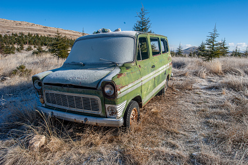 Front and side view of old abandoned green van
