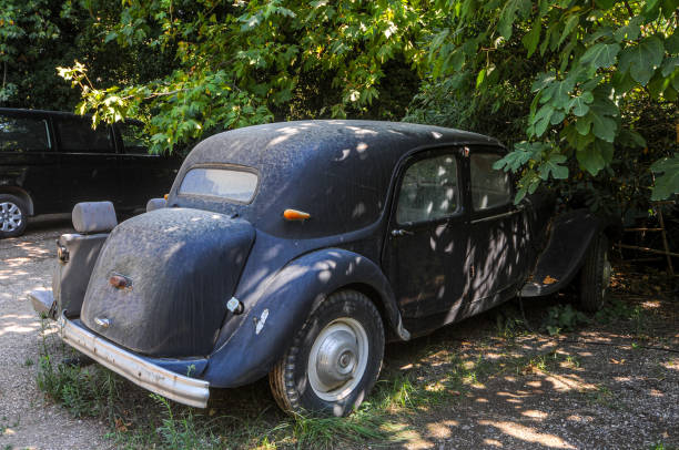Back and side view of a doomed vintage black car