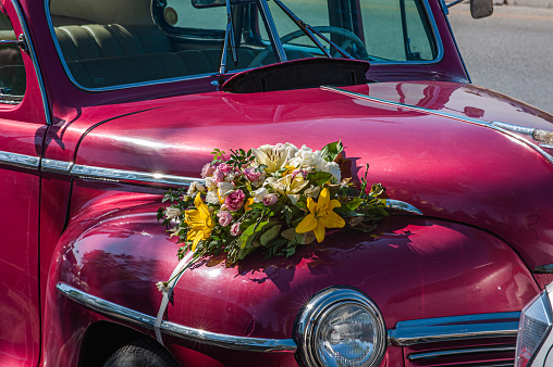 Floral ornaments on a vintage red wedding car