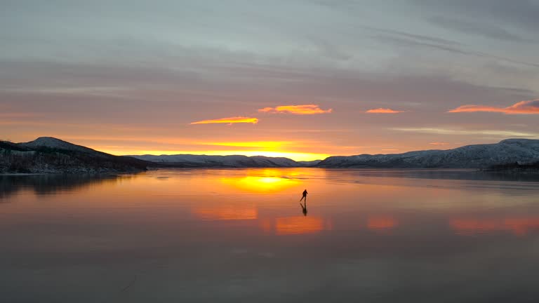 Person skating on a frozen natural ice on large lake