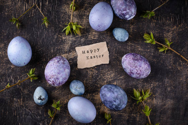 Festive Easter eggs painted with hibiscus tea in purple and blue color