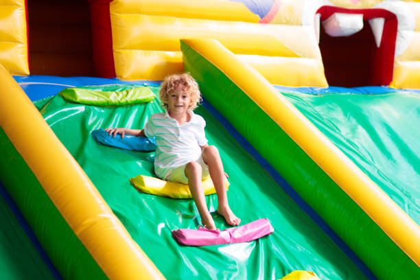 istock Child jumping on playground trampoline. Kids jump. 1460310297