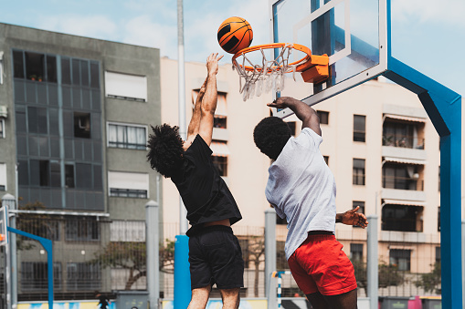 Young African American men playing basketball outdoor - Urban sport lifestyle concept