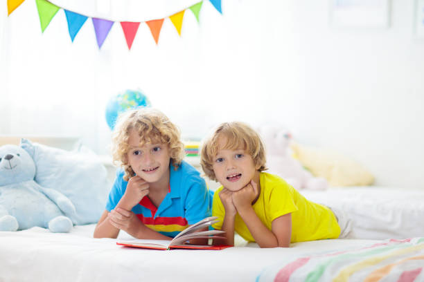 istock Child reading in bed. Kids read. Boy at home. 1460311718