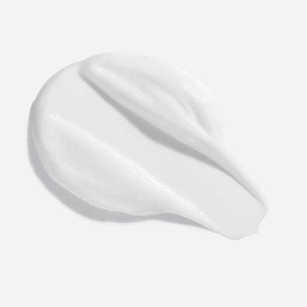 White beauty cream smear smudge on white background. Cosmetic skincare product texture. Face cream, body lotion swipe swatch stock photo